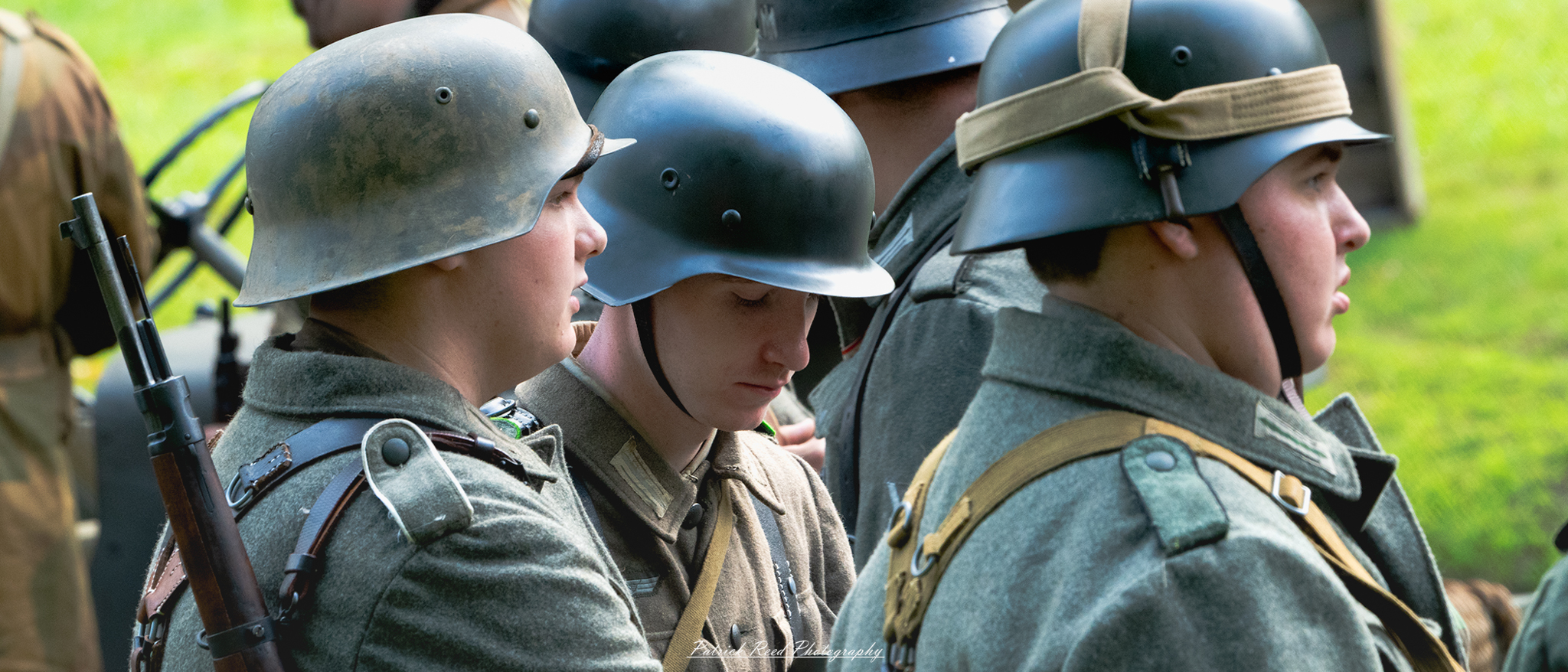 "A somber scene of a German WWII soldier surrounded by his comrades. The image conveys a sense of reflection or loss, highlighting the gravity of the moment in the midst of war."